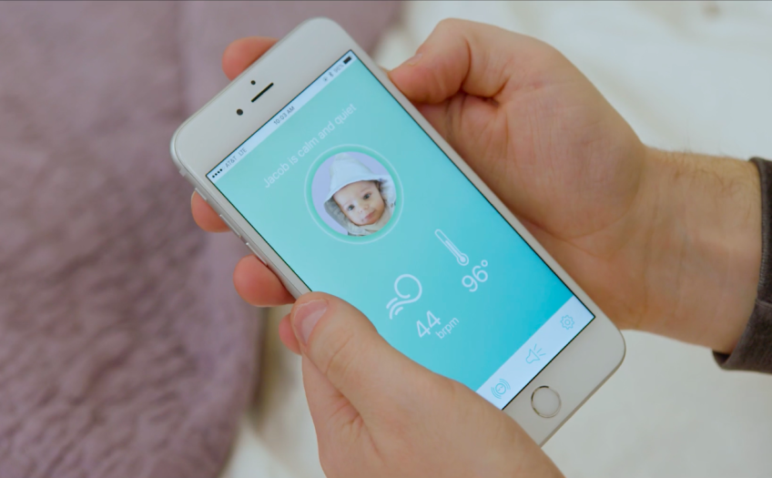 Hands holding a phone that shows the WithMe app.