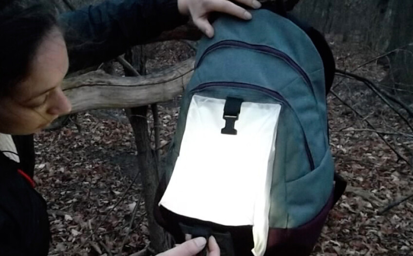 Hands activate the light in a backpack prototype