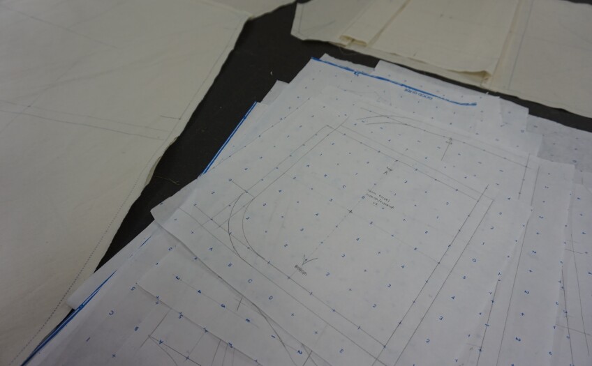 A stack of pattern paper sits on a table.