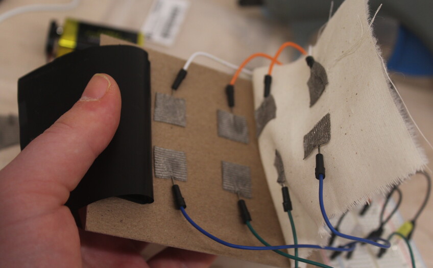 small wires connected to cardboard and fabric