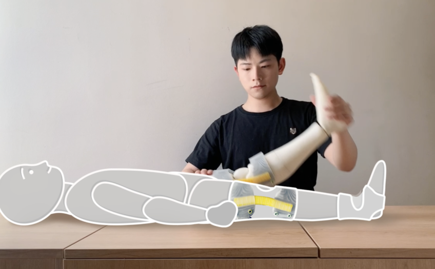 Man manipulates a figure wearing the Mixo-suit