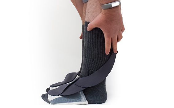 feet in socks with hands holding calves