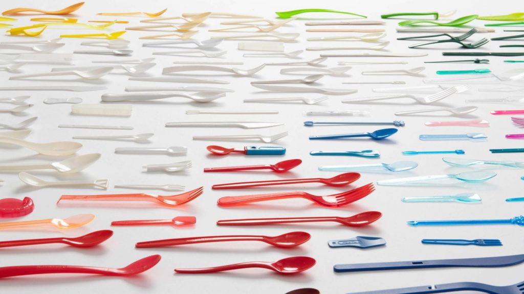 colorful plastic utensils on a white background