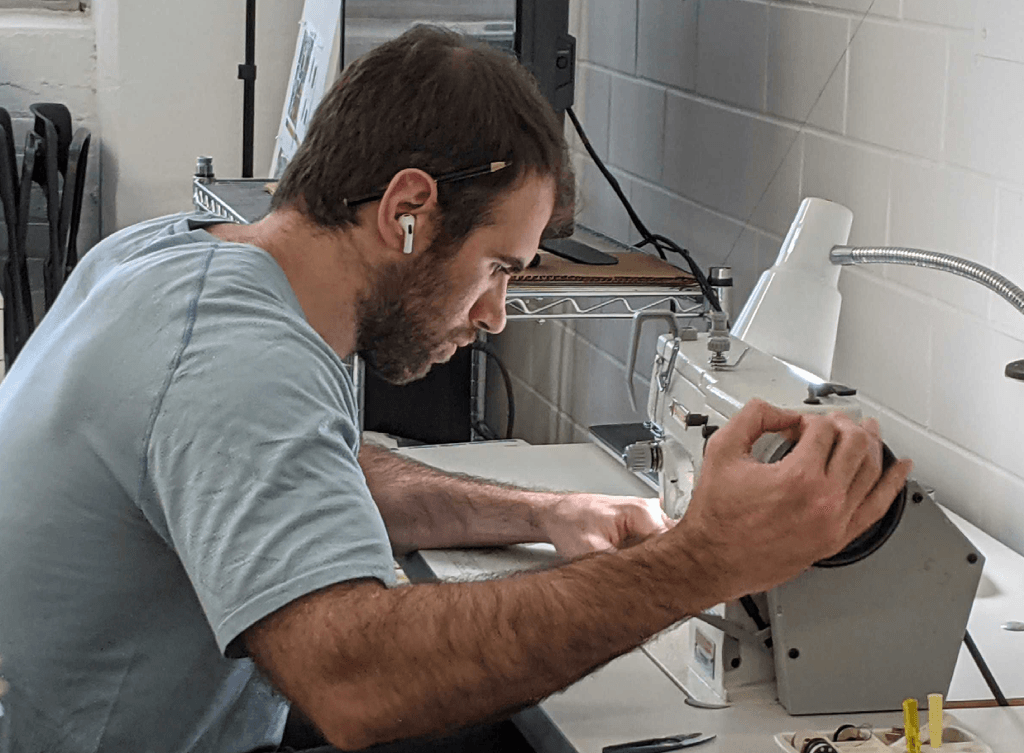 Anthony Parrucci sewing a prototype at Interwoven, working on soft goods design.