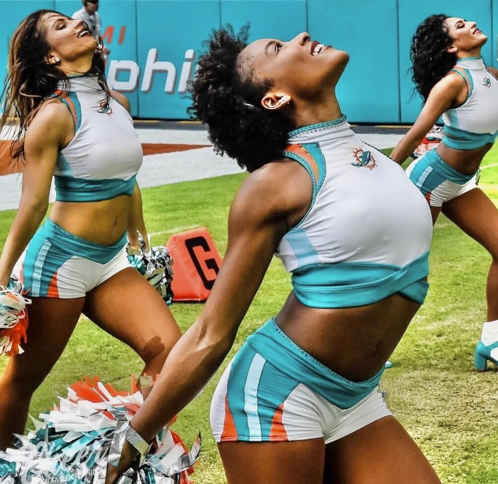 Miami Dolphins cheerleaders performing on the field wearing team performance uniforms