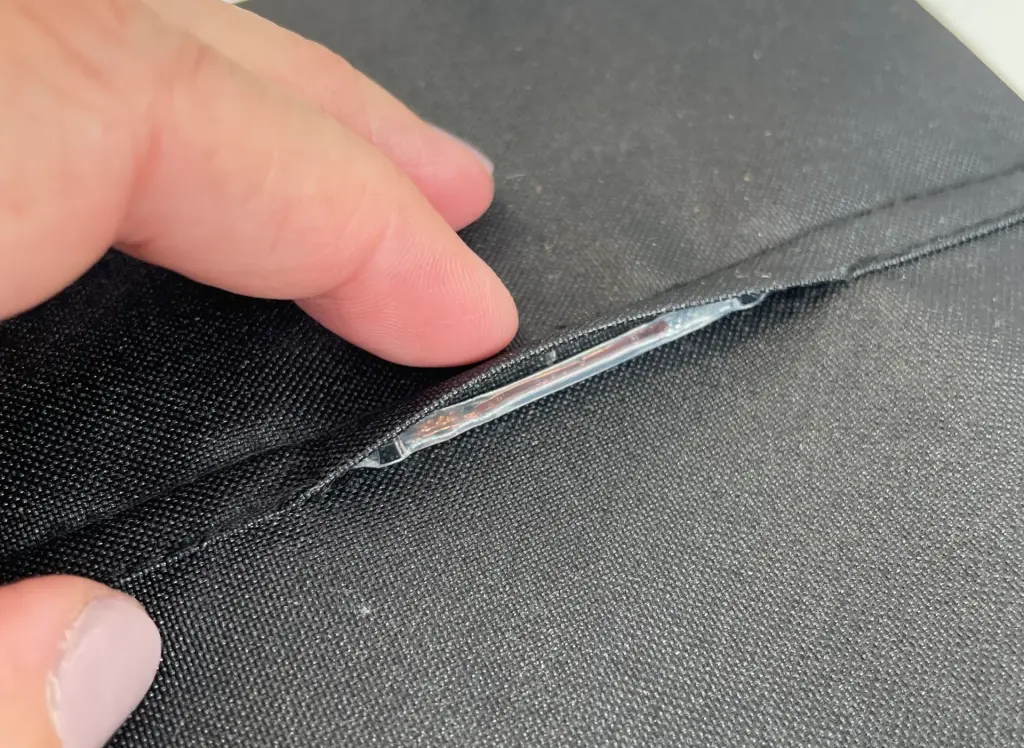 Flexible battery embedded into a black textile swatch as a smart textile prototype