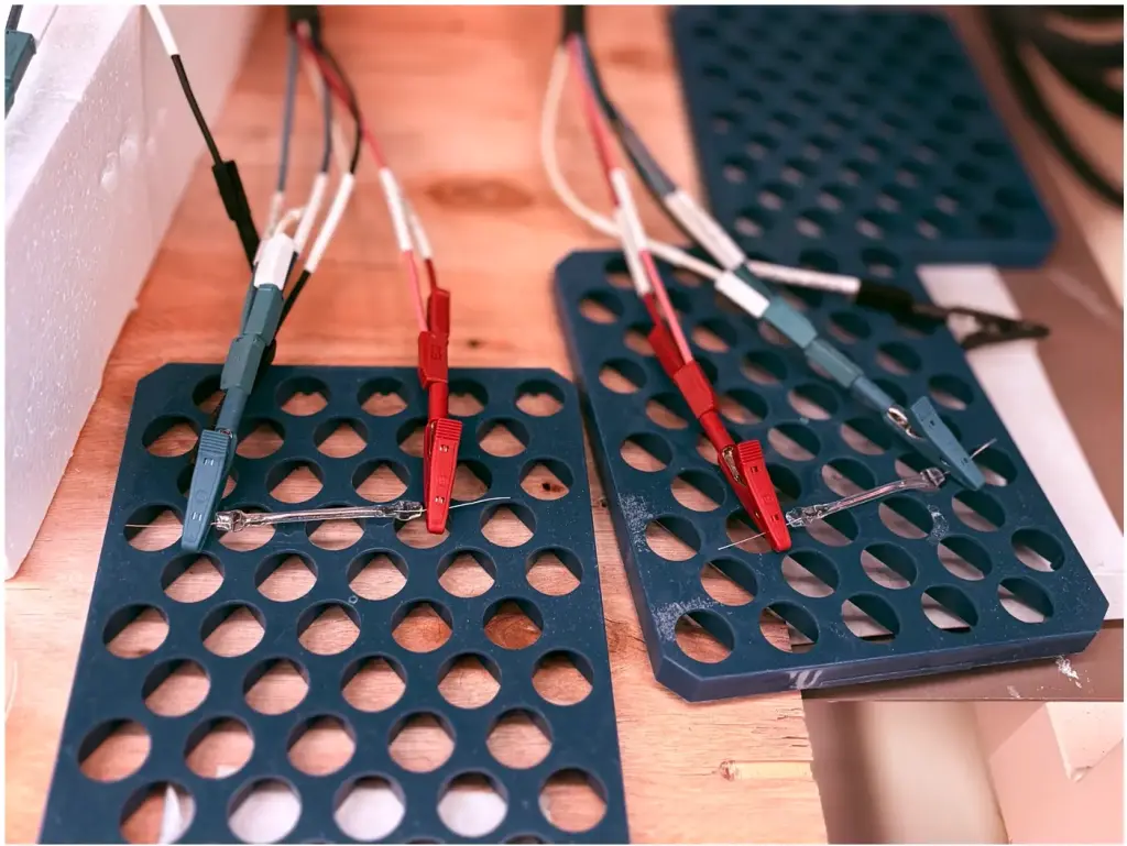 Flexible batteries connected to test leads for performance and durability evaluation