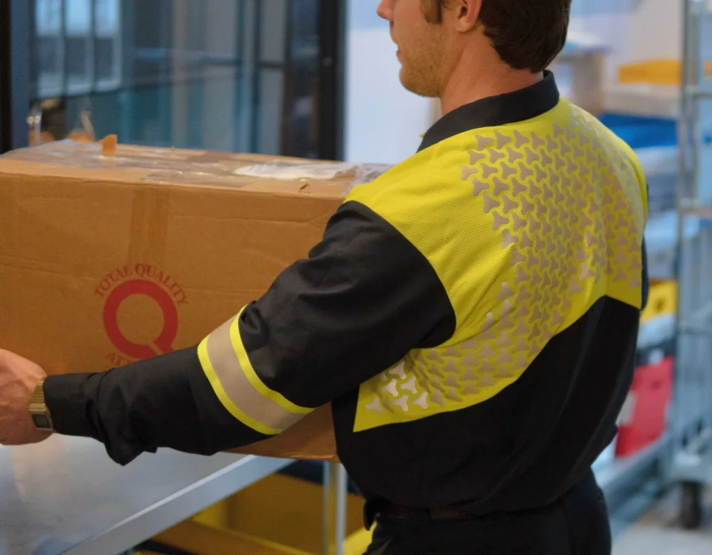Worker wearing a high-visibility Project Firefly workwear garment with reflective material across the back and sleeves